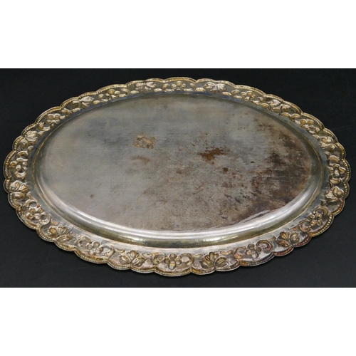 379 - An oval Continental silver coloured metal scallop shaped dish with embossed floral and scroll rim, 2... 