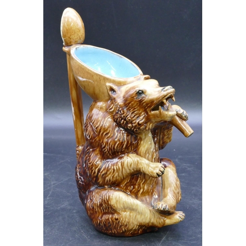 38 - A Majolica jug in the form of a seated bear with spoon shaped handle, circa 1870, 23cm high.