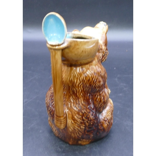 38 - A Majolica jug in the form of a seated bear with spoon shaped handle, circa 1870, 23cm high.