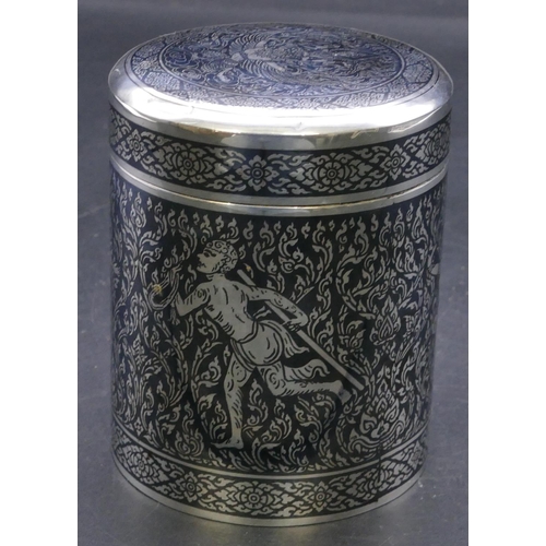 384 - A sterling silver niello cylindrical lidded pot with figure, leaf and scroll decoration (with later ... 