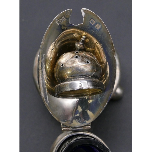 388 - An oval silver mustard pot with hinged lid enclosing blue glass liner (marks rubbed), a Birmingham s... 