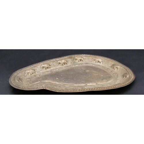 392 - An Eastern silver coloured metal scallop shaped tray with embossed elephant and scroll decoration, 3... 