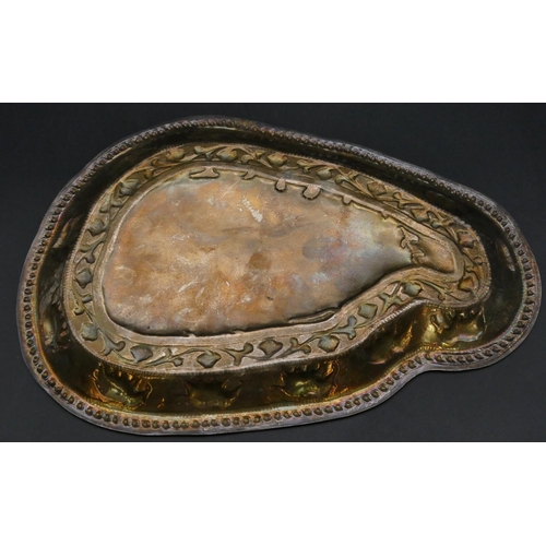 392 - An Eastern silver coloured metal scallop shaped tray with embossed elephant and scroll decoration, 3... 