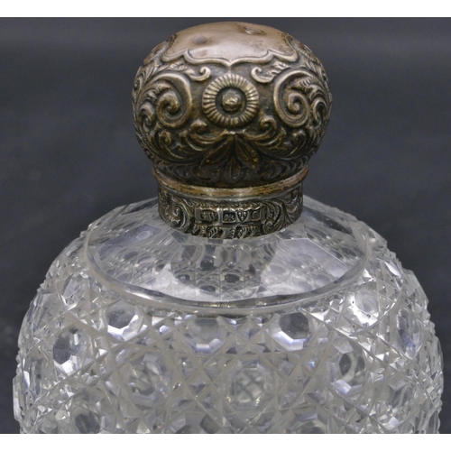 393 - An Edward VII cut glass round bulbous shaped scent bottle with silver screw lid with embossed floral... 