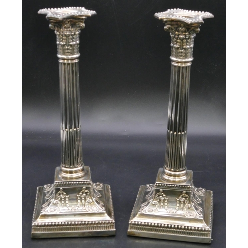 394 - A pair of Victorian silver Corinthian column candlesticks with embossed square sweeping bases, Sheff... 