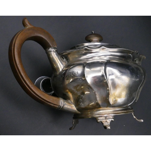 395 - A late Victorian oval silver teapot with wooden handle and finial on splayed feet, London, 1900, 22.... 