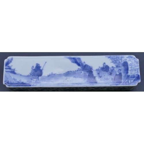 40 - An Oriental blue and white rectangular scroll weight with figure, landscape, floral and scroll decor... 