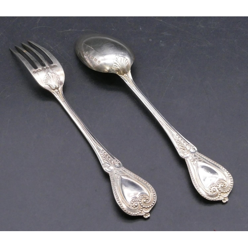 403 - A Victorian silver child's spoon, knife and fork with raised scroll decoration, Birmingham 1864 and ... 