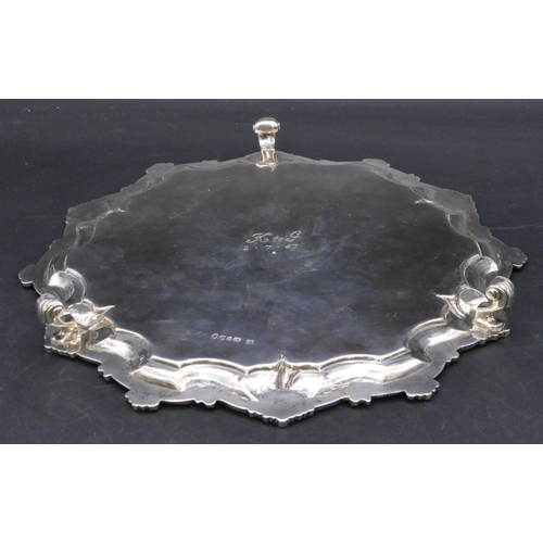 408 - A Victorian silver pie crust card tray with raised shell decoration with engraved centre on 3 scroll... 