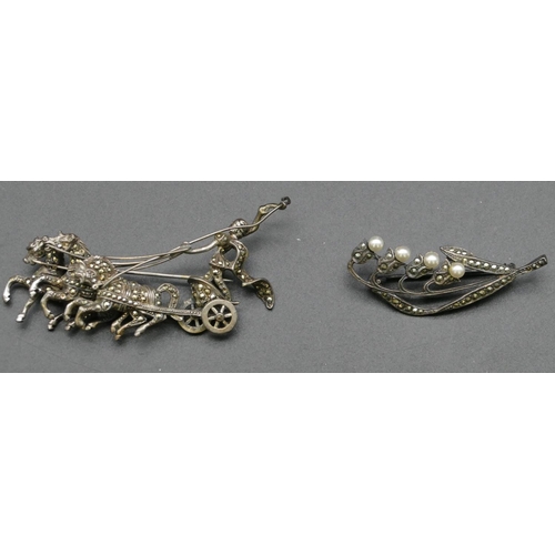 423 - A silver coloured metal and cut steel brooch in the form of a horse drawn chariot, 6.5cm long, anoth... 