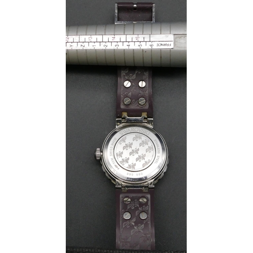 431 - A modern Swarovski wrist watch with purple dial, seconds hand and calendar (needs battery).