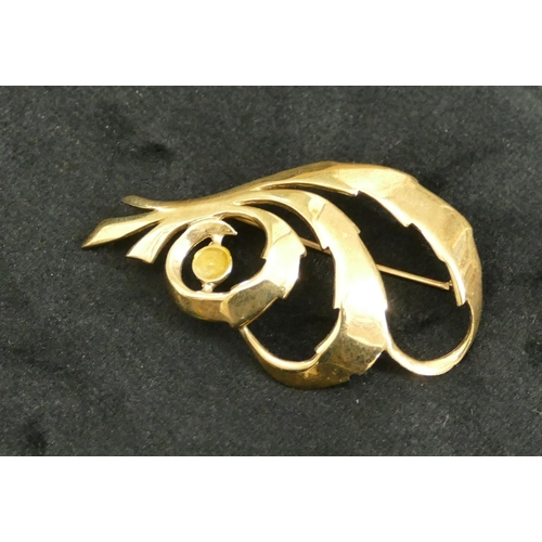 439 - A 9ct gold scroll shaped brooch set with small pearl (pearl missing), 5cm long, 6 grams.