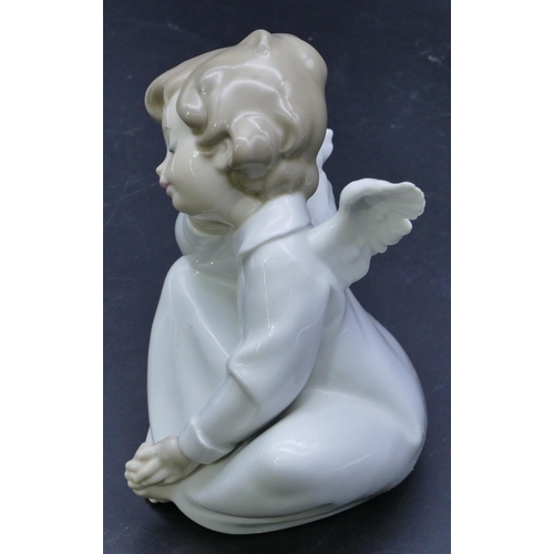 44 - A Lladro figure of a seated angel, 16.5cm high.