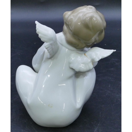 44 - A Lladro figure of a seated angel, 16.5cm high.