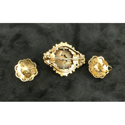 444 - A 9ct gold garnet brooch mounted with half pearls, 4cm long and a pair of matching screw earrings, o... 