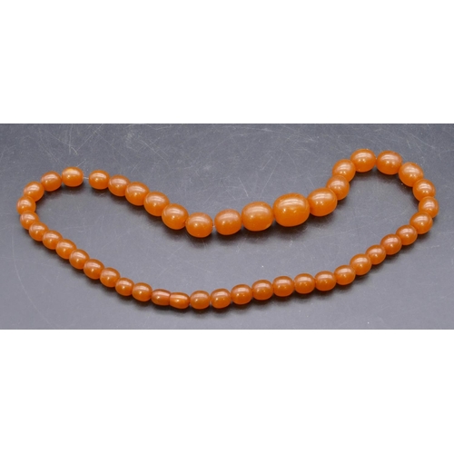 445 - An amber style graduated bead necklace.