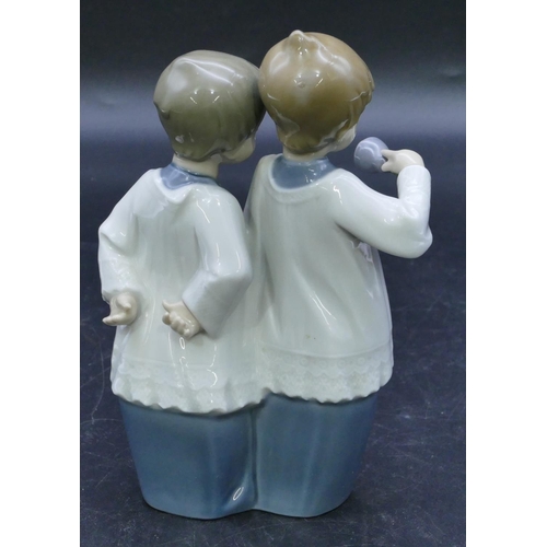 45 - A Nao figure of 2 standing choir boys holding a bell, 17.5cm high.