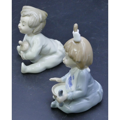 46 - 2 Nao figures of seated babies with bottle and bowl, largest 12.5cm high. (2)