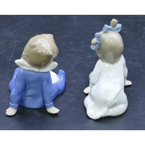 47 - 2 Nao figures of a seated and a crawling baby holding plates, largest 11cm high. (2)