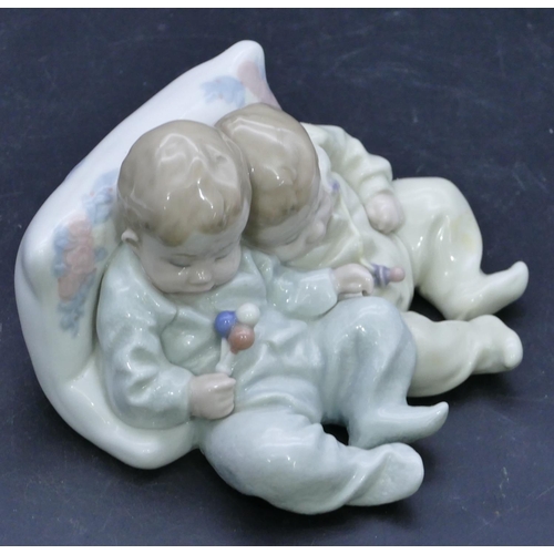 48 - A Lladro group of 2 sleeping babies on a cushion, 14cm wide.