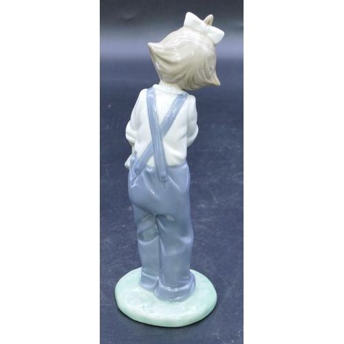 49 - A Nao figure of a young standing girl holding a rag doll, 18.5cm high.