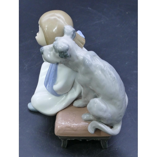 54 - A Lladro group of a young seated girl and dog on pouffe, 16cm high.
