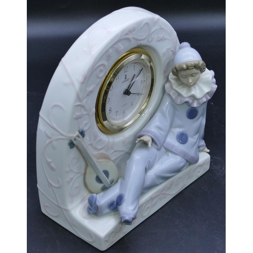 55 - A Lladro clock with raised figure of a seated pierrot 21cm high (working).