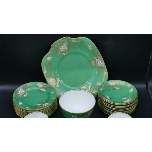 62 - A Crown Staffordshire tea service on green ground with white and gilt floral and leaf decoration, ca... 