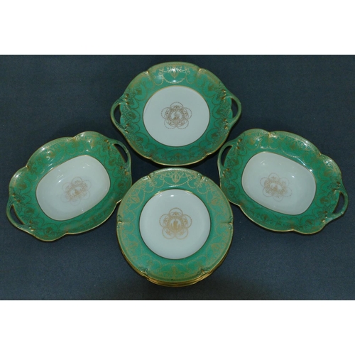 64 - A Wedgewood fruit service W1505 on white and green ground with all over gilt figure, swag and scroll... 