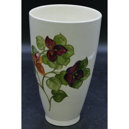 65 - A Moorcroft round trumpet shaped vase on cream ground with multi-coloured floral and leaf decoration... 