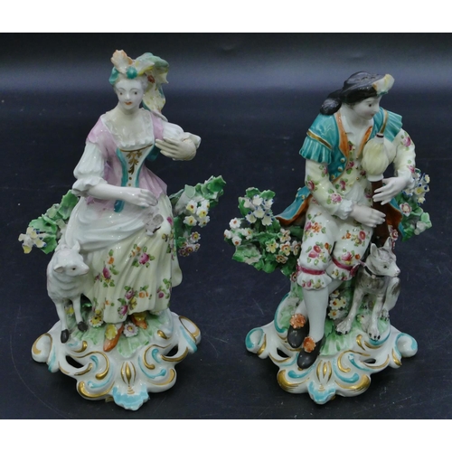 72 - A pair of Derby porcelain figures of seated gentleman and lady with sheep and dog at their feet with... 