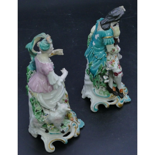 72 - A pair of Derby porcelain figures of seated gentleman and lady with sheep and dog at their feet with... 