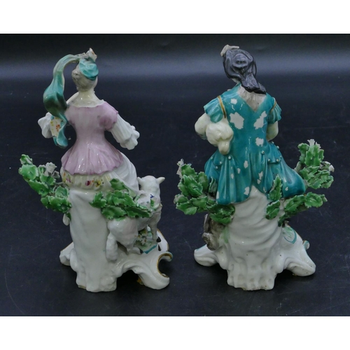 72 - A pair of Derby porcelain figures of seated gentleman and lady with sheep and dog at their feet with... 