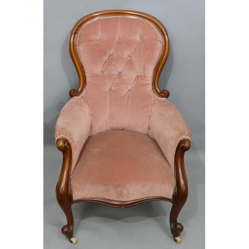 742 - A Victorian mahogany spoonback armchair with pink velvet over stuffed seat, button back and padded a... 