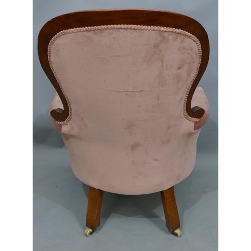 742 - A Victorian mahogany spoonback armchair with pink velvet over stuffed seat, button back and padded a... 