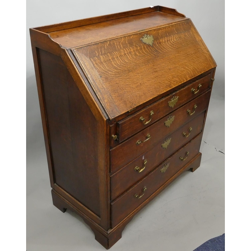 744 - A George III oak bureau with lipped gallery, full front enclosing fitted interior, 4 long graduated ... 