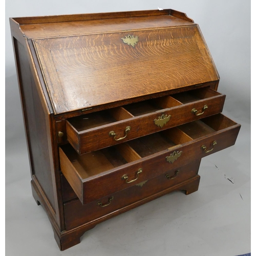 744 - A George III oak bureau with lipped gallery, full front enclosing fitted interior, 4 long graduated ... 