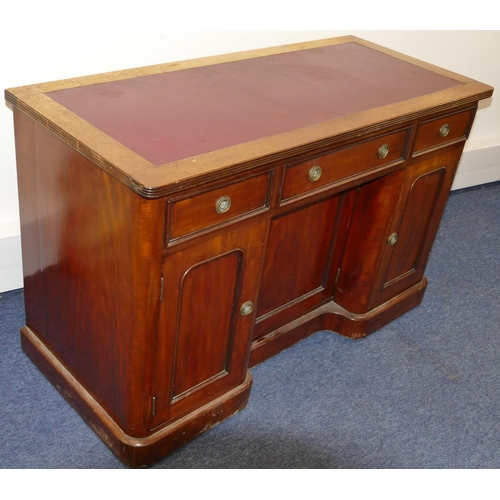 748 - A 19th Century mahogany kneehole writing desk with red inset top, centre drawer flanked by 2 smaller... 