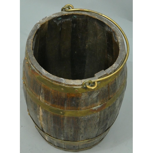 758 - An oak and brass bound round bulbous shaped bucket with swing overhead handle, 44.5cm high.