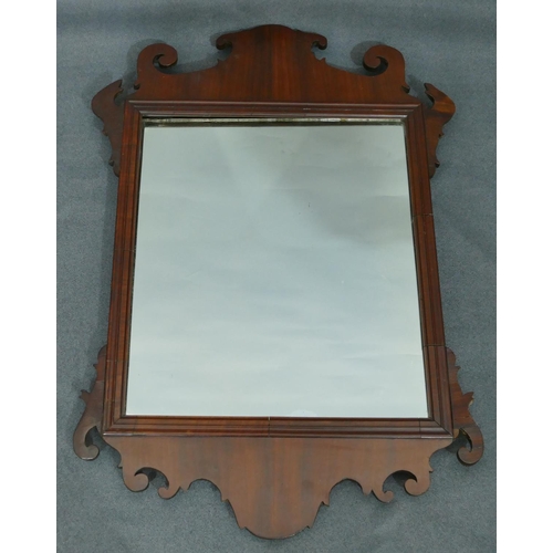 759 - A 19th Century mahogany wall mirror with scallop shaped rim, 70cm high, 48cm wide.