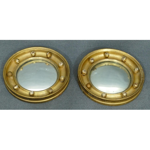 764 - A pair of small 19th Century convex wall mirrors with inner ball motifs, each 20.3cm diameter.