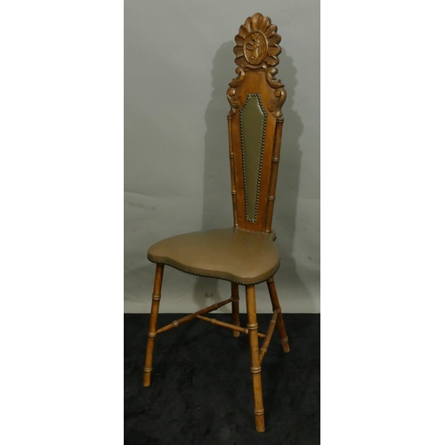 775 - A mahogany hall chair with a narrow carved back, leather overstuffed seat and part back on round tur... 