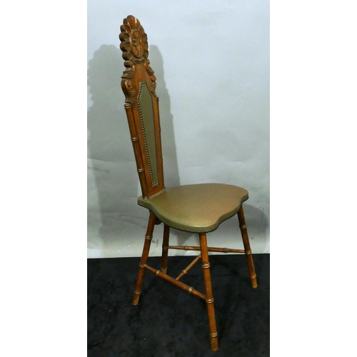 775 - A mahogany hall chair with a narrow carved back, leather overstuffed seat and part back on round tur... 