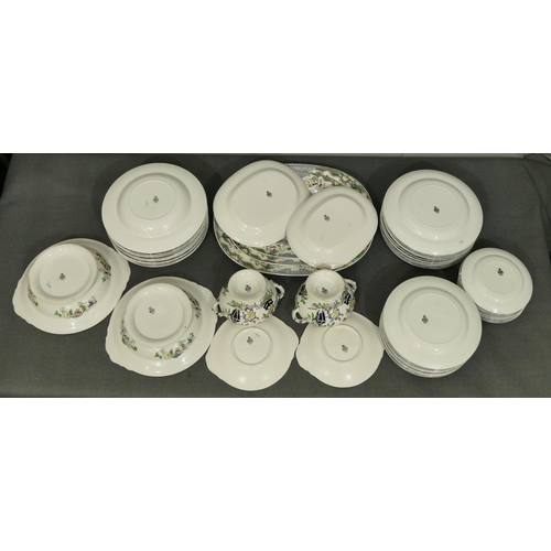 91 - A Mintons dinner service on white and black ground with multi-coloured vase, floral and scroll decor... 