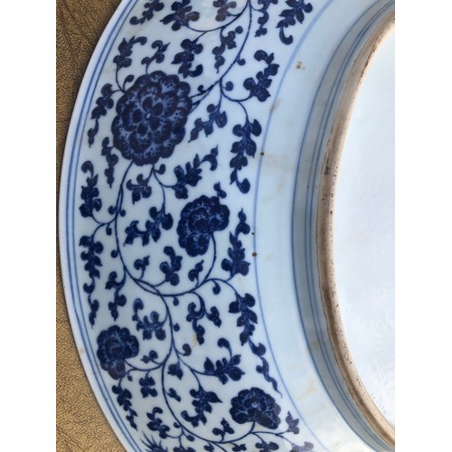 149 - A Chinese 18/19th Century Qianlong blue and white large charger with an allover dragon, floral, leaf... 