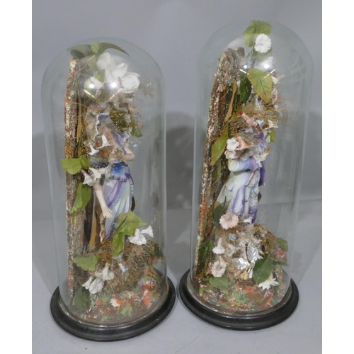 100 - A pair of Bisque china figures of gentleman and lady on blue and white ground, mounted under glass d... 