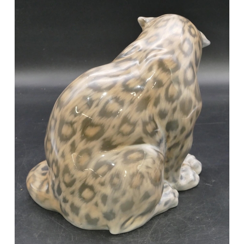 105 - A Royal Copenhagen figure of a seated snow leopard, number 2555, 20.5cm high