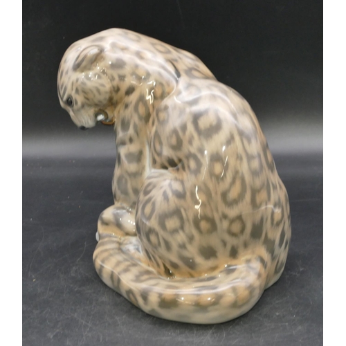 105 - A Royal Copenhagen figure of a seated snow leopard, number 2555, 20.5cm high