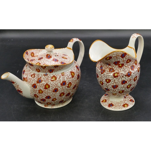 106 - A 19th Century Pearlware round bulbous shaped teapot and matching cream jug on white and red ground ... 