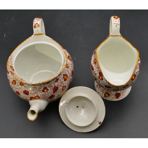 106 - A 19th Century Pearlware round bulbous shaped teapot and matching cream jug on white and red ground ... 